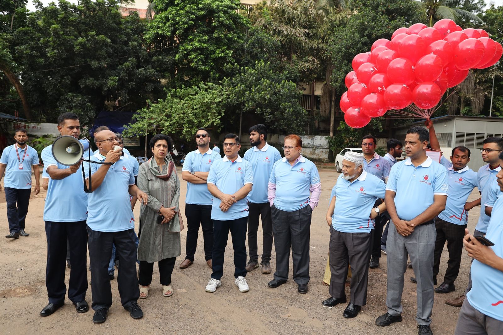 Staff gather in front of the hospital.