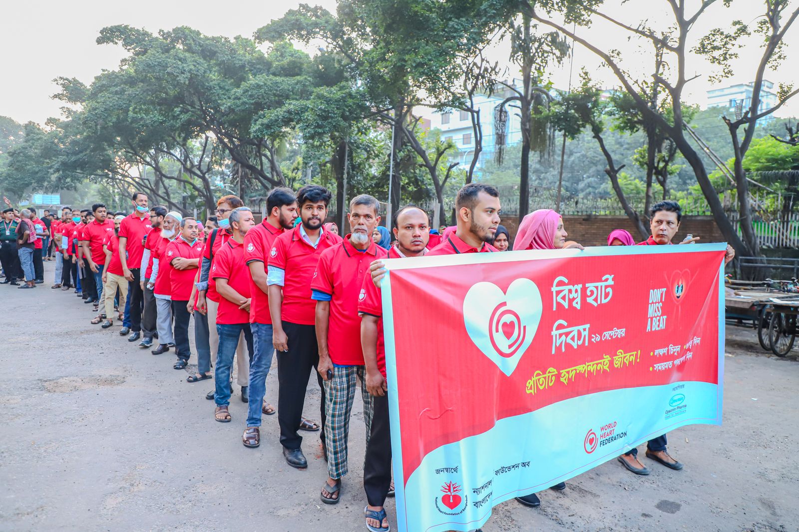 Lining up behind the banner at the stadium at dawn.